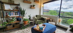 view of Stephanie's Brentwood office with shelving and a large window