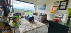 view of Stephanie's Brentwood office with furniture and a large window