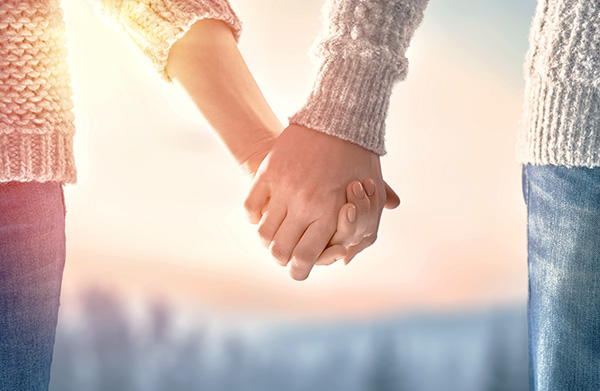 photo of a couple holding hands